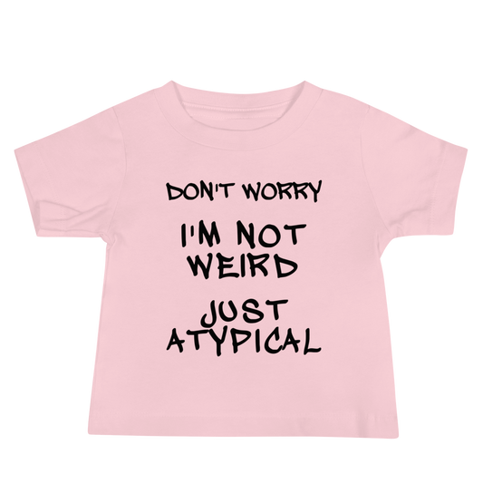 "Don't Worry I'm Not Weird Just Atypical" printed on a pink baby jersey short sleeve tee laying on a flat surface