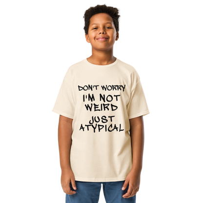 "Don't Worry I'm Not Weird Just Atypical" printed on a natural youth classic tee worn by a male