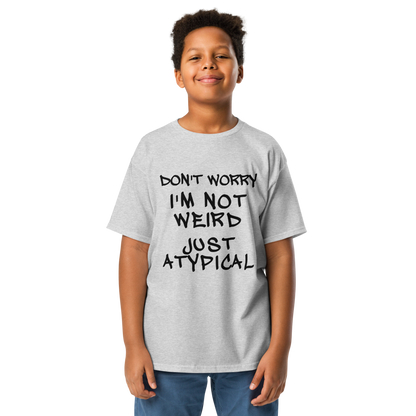 "Don't Worry I'm Not Weird Just Atypical" printed on a sport grey youth classic tee worn by a male