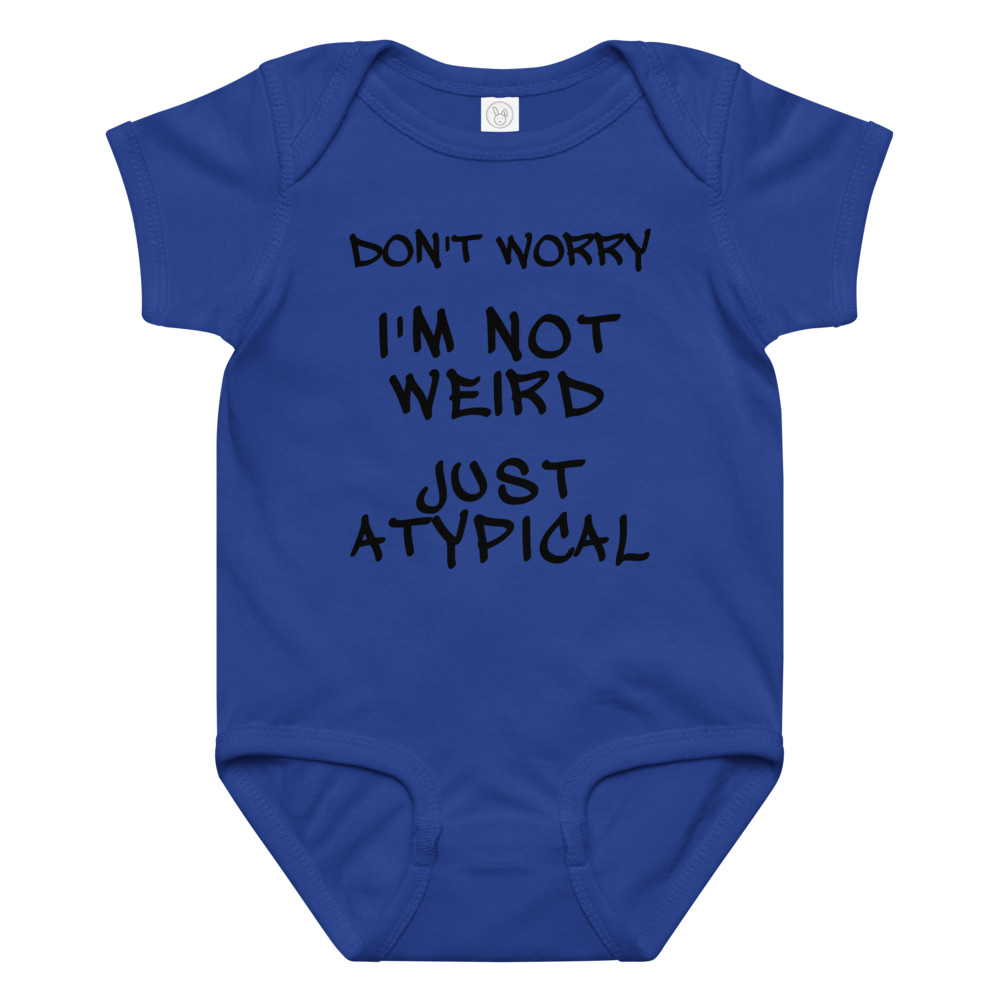"Don't Worry I'm Not Weird Just Atypical" printed on a royal baby jersey bodysuit laying on a flat surface amongst other clothes