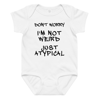 "Don't Worry I'm Not Weird Just Atypical" printed on a white baby jersey bodysuit laying on a flat surface amongst other clothes