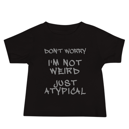 "Don't Worry I'm Not Weird Just Atypical" printed on a black baby jersey short sleeve tee laying on a flat surface