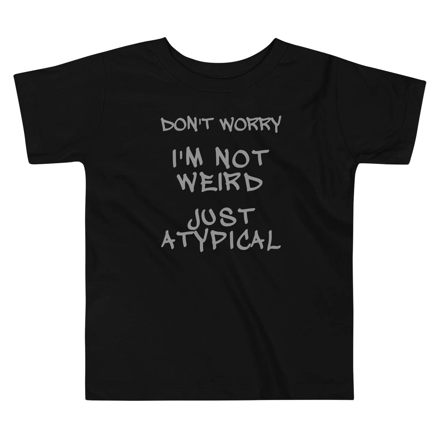 "Don't Worry I'm Not Weird Just Atypical" printed on a black toddler short sleeve tee laying on a flat surface