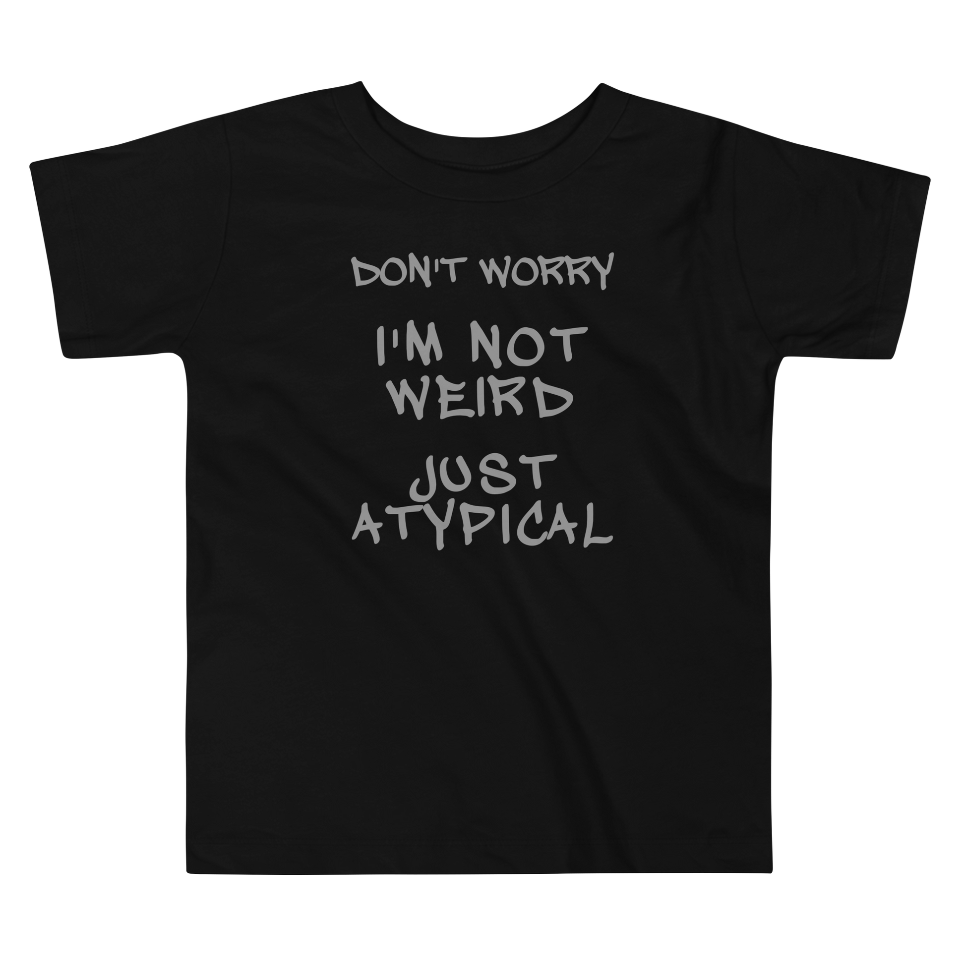 "Don't Worry I'm Not Weird Just Atypical" printed on a black toddler short sleeve tee laying on a flat surface