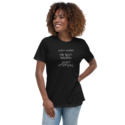 "Don't Worry I'm Not Weird Just Atypical" printed on a black women's relaxed t-shirt worn by a female