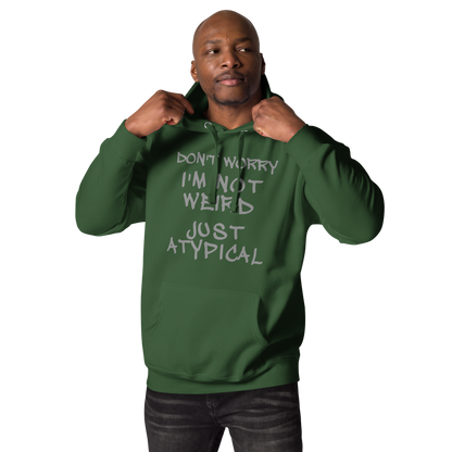 "Don't Worry I'm Not Weird Just Atypical" printed on a forest green unisex hoodie worn by a male