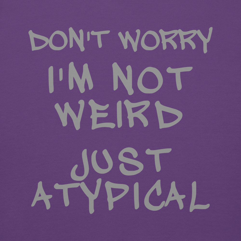 "Don't Worry I'm Not Weird Just Atypical" printed on a purple background