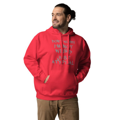 "Don't Worry I'm Not Weird Just Atypical" printed on a team red unisex hoodie worn by a male