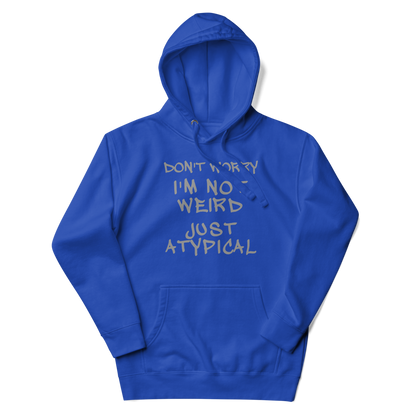 "Don't Worry I'm Not Weird Just Atypical" printed on a team royal unisex hoodie laying on a flat surface with the hood up