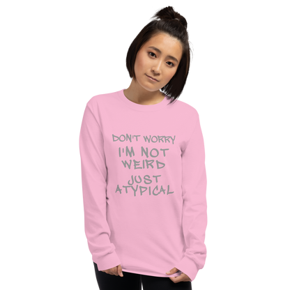 "Don't Worry I'm Not Weird Just Atypical" printed on a light pink men's long sleeve shirt worn by a female