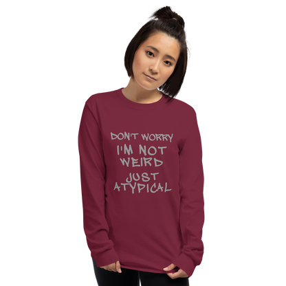 "Don't Worry I'm Not Weird Just Atypical" printed on a maroon men's long sleeve shirt worn by a female
