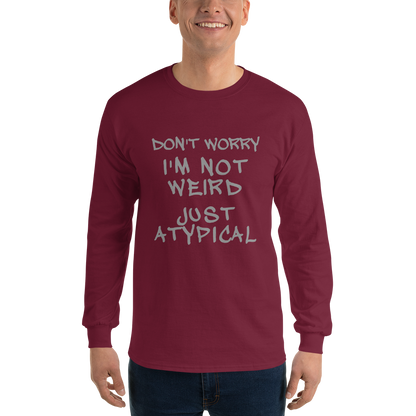 "Don't Worry I'm Not Weird Just Atypical" printed on a maroon men's long sleeve shirt worn by a male