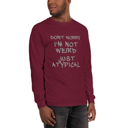 "Don't Worry I'm Not Weird Just Atypical" printed on a maroon men's long sleeve shirt worn by a male