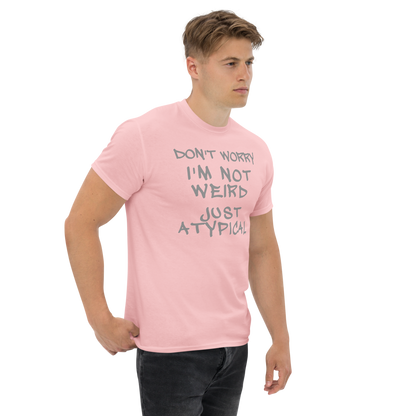 "Don't Worry I'm Not Weird Just Atypical" printed on a light pink unisex classic tee worn by a male