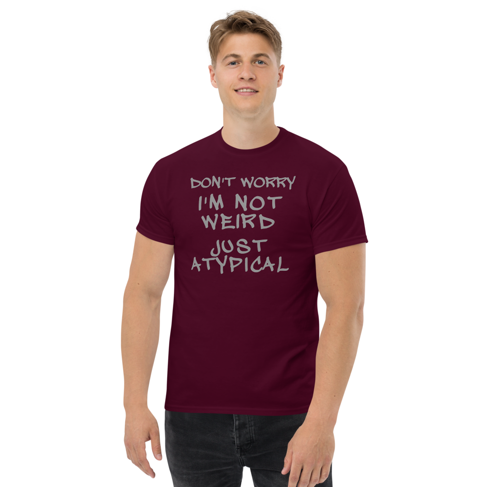 "Don't Worry I'm Not Weird Just Atypical" printed on a maroon unisex classic tee worn by a male