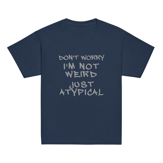 "Don't Worry I'm Not Weird Just Atypical" printed on a navy youth classic tee laying on a flat surface