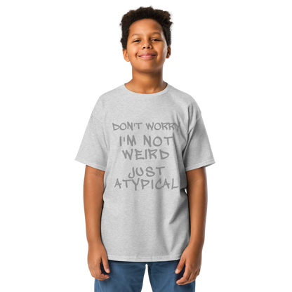 "Don't Worry I'm Not Weird Just Atypical" printed on a sport grey youth classic tee worn by a male