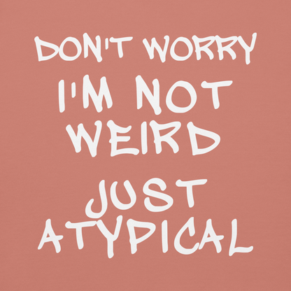 "Don't Worry I'm Not Weird Just Atypical" printed on a dusty rose background