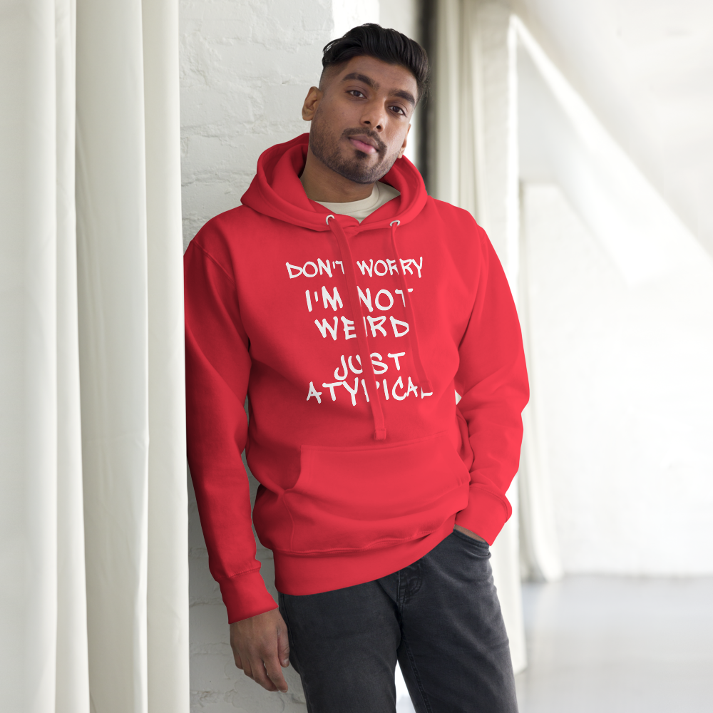 "Don't Worry I'm Not Weird Just Atypical" printed on a team red unisex hoodie worn by a male