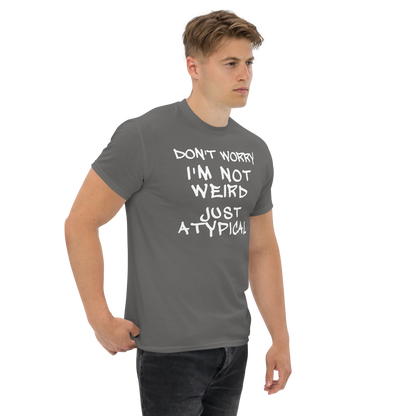 "Don't Worry I'm Not Weird Just Atypical" printed on a charcoal unisex classic tee worn by a male