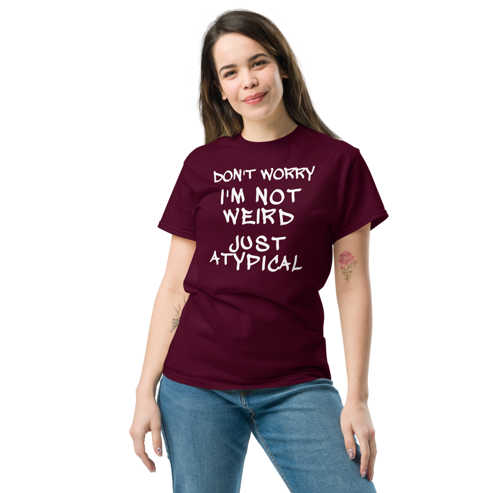 "Don't Worry I'm Not Weird Just Atypical" printed on a maroon unisex classic tee worn by a female