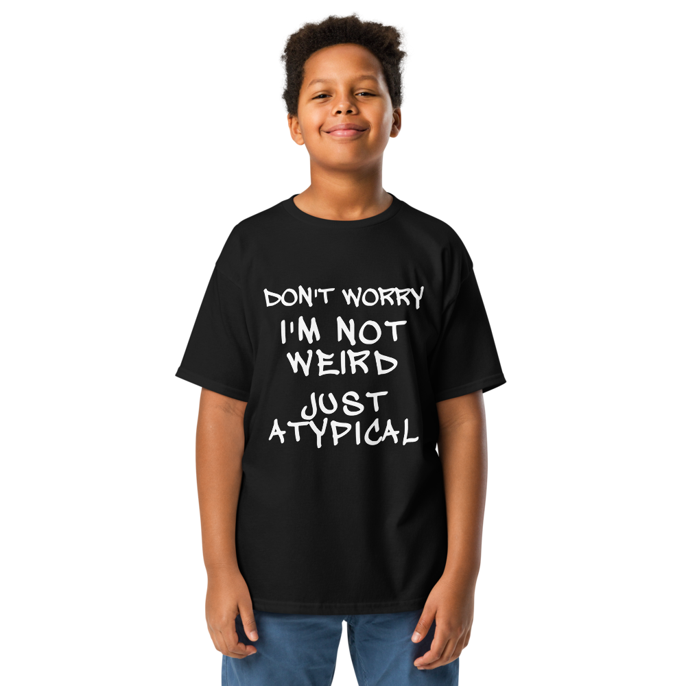 "Don't Worry I'm Not Weird Just Atypical" printed on a black youth classic tee worn by a male