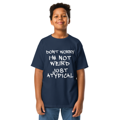 "Don't Worry I'm Not Weird Just Atypical" printed on a navy youth classic tee worn by a male