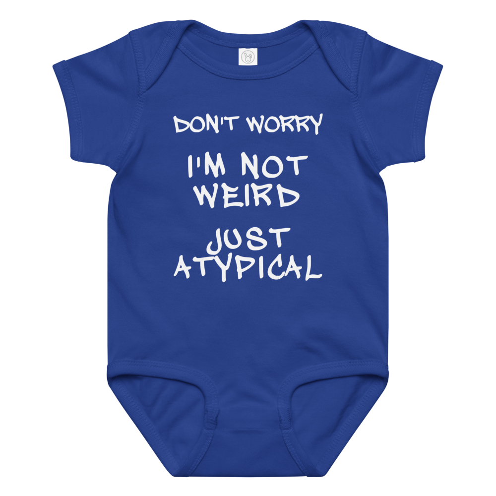 "Don't Worry I'm Not Weird Just Atypical" printed on a royal baby jersey bodysuit laying on a flat surface amongst other clothes
