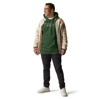 "Forget Average, Be Awesome!" printed on a forest green unisex hoodie worn by a male with a jacket on top