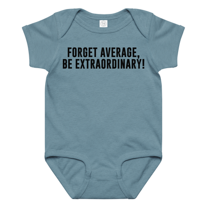 "Forget Average, Be Extraordinary!" printed on a vintage indigo baby jersey bodysuit laying on a flat surface amongst other clothes