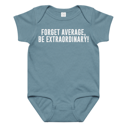"Forget Average, Be Extraordinary!" printed on a vintage indigo baby jersey bodysuit laying on a flat surface amongst other clothes