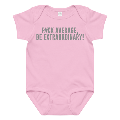 "F#Ck Average, Be Extraordinary!" printed on a pink baby jersey bodysuit laying on a flat surface amongst other clothes