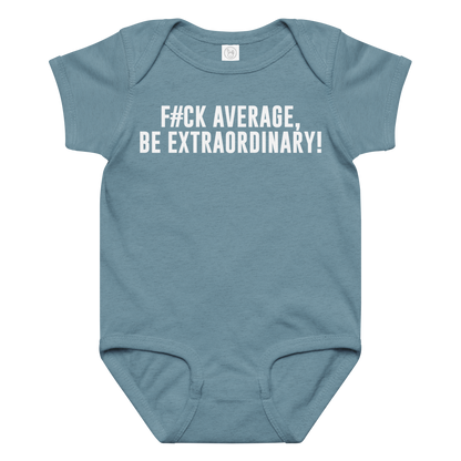 "F#Ck Average, Be Extraordinary!" printed on a vintage indigo baby jersey bodysuit laying on a flat surface amongst other clothes