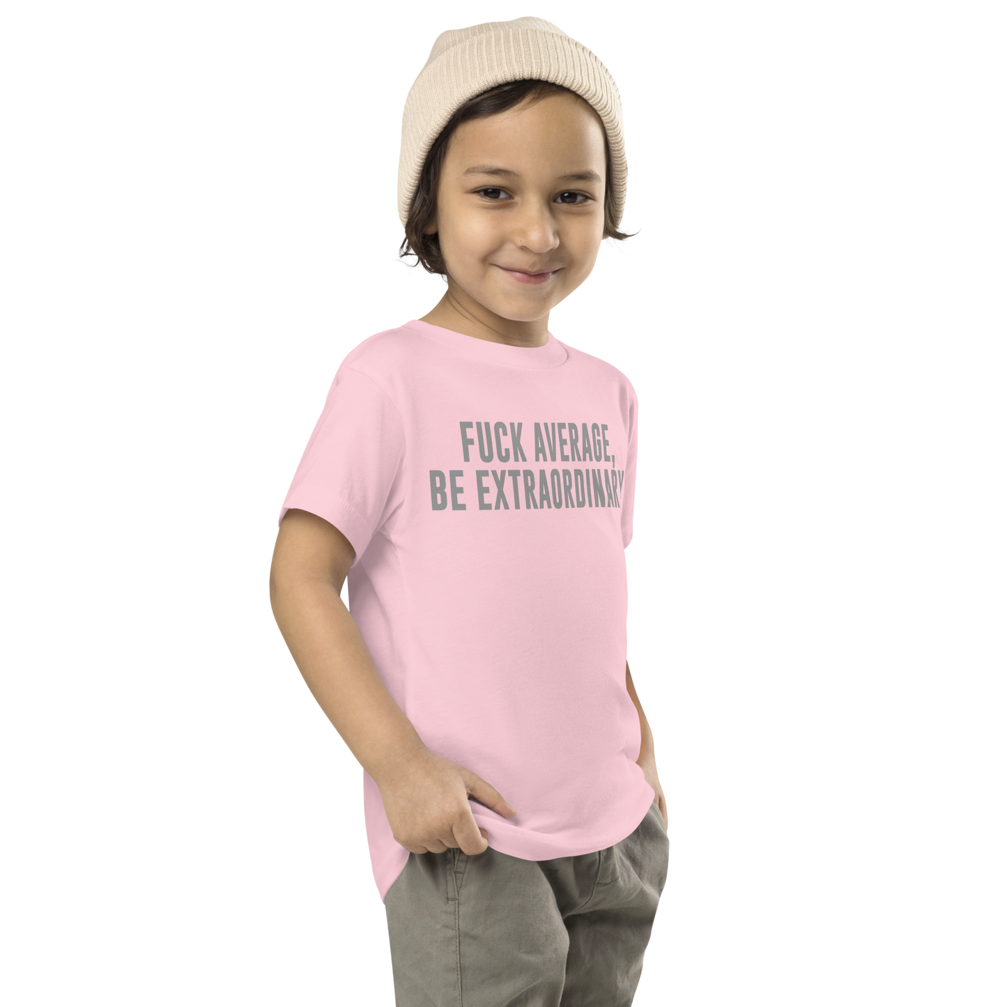 "Fuck Average, Be Extraordinary!" printed on a pink toddler short sleeve tee worn by a male who is also wearing a knit cap