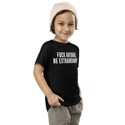 "Fuck Average, Be Extraordinary!" printed on a black toddler short sleeve tee worn by a male who is also wearing a knit cap