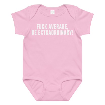 "Fuck Average, Be Extraordinary!" printed on a pink baby jersey bodysuit laying on a flat surface amongst other clothes