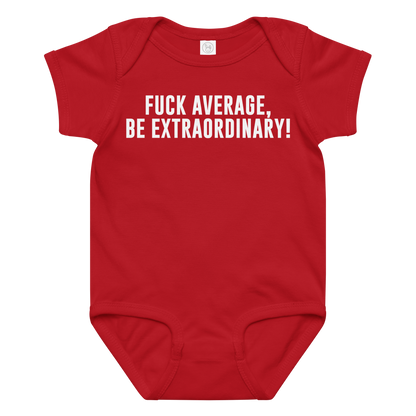 "Fuck Average, Be Extraordinary!" printed on a red baby jersey bodysuit laying on a flat surface amongst other clothes