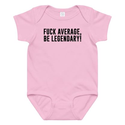 "Fuck Average, Be Legendary!" printed on a pink baby jersey bodysuit laying on a flat surface amongst other clothes