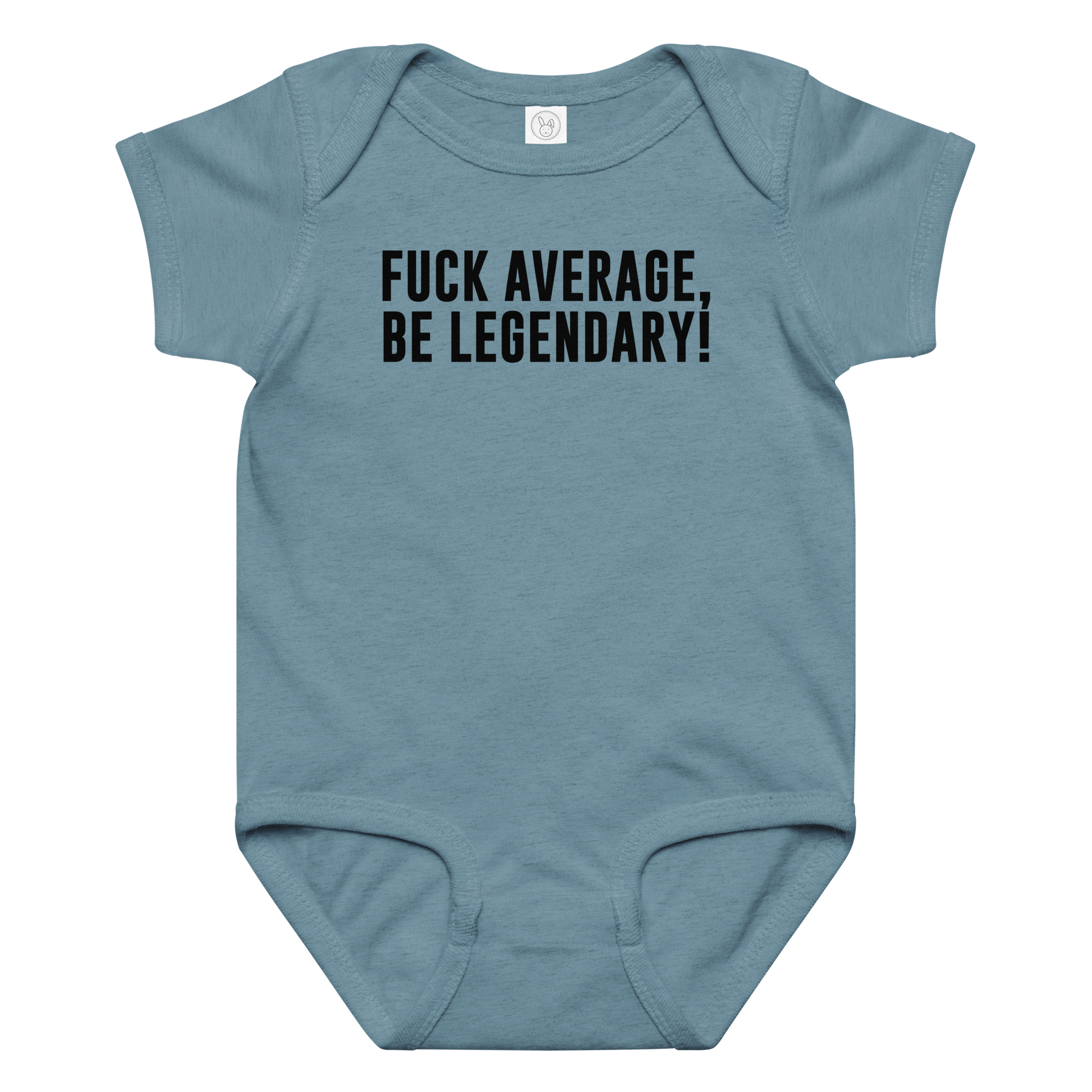 "Fuck Average, Be Legendary!" printed on a vintage indigo baby jersey bodysuit laying on a flat surface amongst other clothes