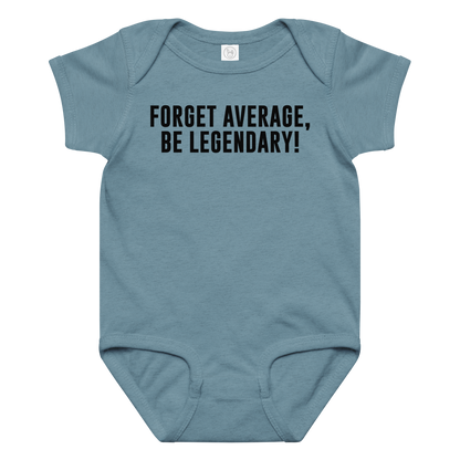 "Forget Average, Be Legendary!" printed on a vintage indigo baby jersey bodysuit laying on a flat surface amongst other clothes