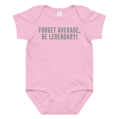 "Forget Average, Be Legendary!" printed on a pink baby jersey bodysuit laying on a flat surface amongst other clothes