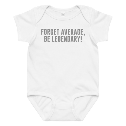 "Forget Average, Be Legendary!" printed on a white baby jersey bodysuit laying on a flat surface amongst other clothes