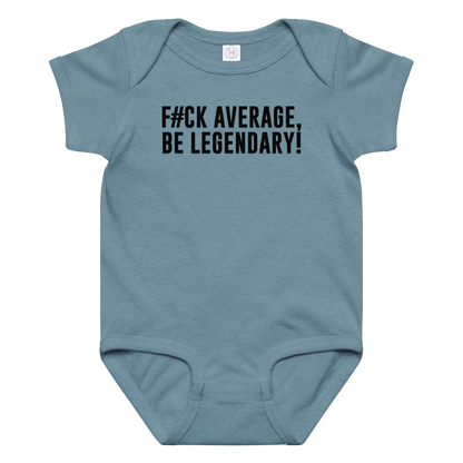 "F#Ck Average, Be Legendary!" printed on a vintage indigo baby jersey bodysuit laying on a flat surface amongst other clothes