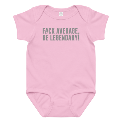 "F#Ck Average, Be Legendary!" printed on a pink baby jersey bodysuit laying on a flat surface amongst other clothes