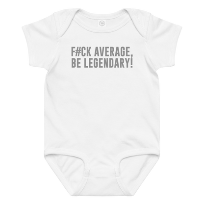 "F#Ck Average, Be Legendary!" printed on a white baby jersey bodysuit laying on a flat surface amongst other clothes