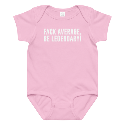 "F#Ck Average, Be Legendary!" printed on a pink baby jersey bodysuit laying on a flat surface amongst other clothes