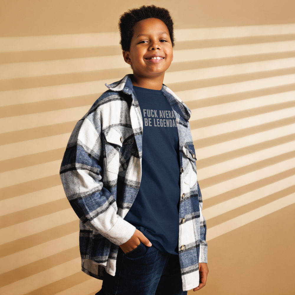 "Fuck Average, Be Legendary!" printed on a navy youth classic tee worn by a male also wearing a jacket