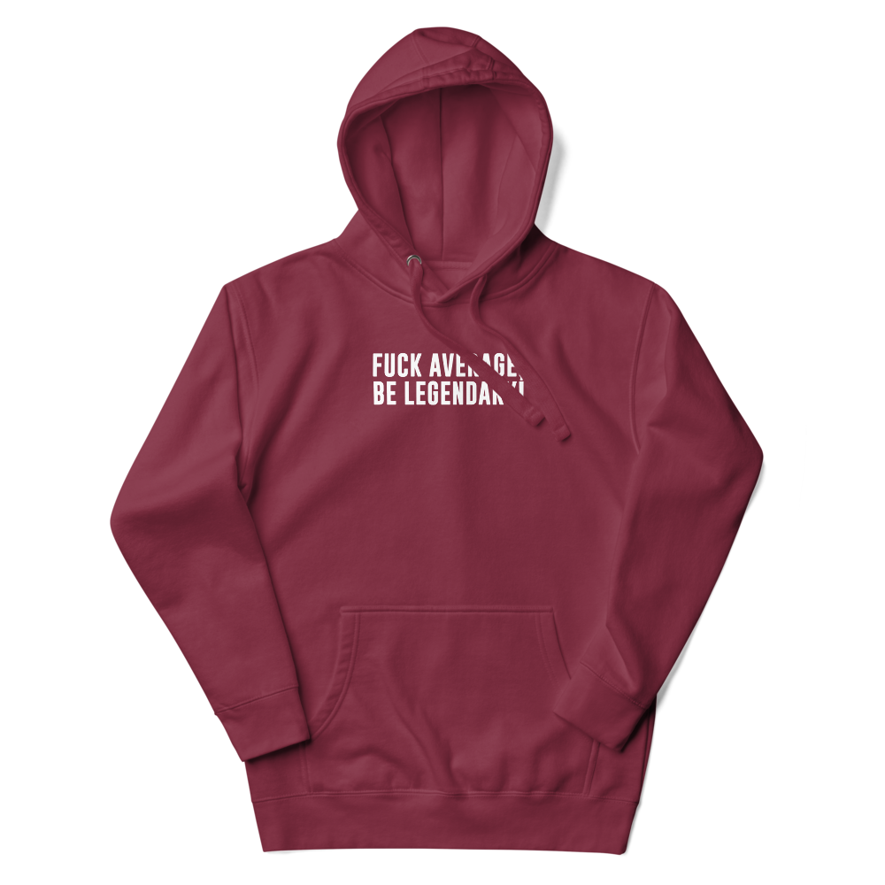"Fuck Average, Be Legendary!" printed on a maroon unisex hoodie laying on a flat surface with the hood up