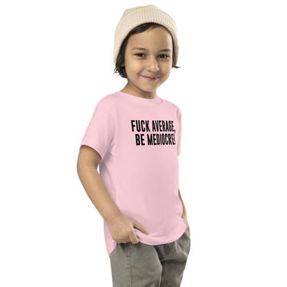 "Fuck Average, Be Mediocre!" printed on a pink toddler short sleeve tee worn by a male who is also wearing a knit cap