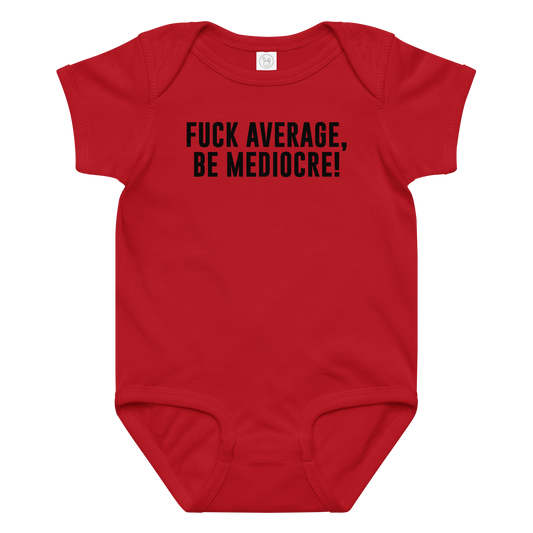 "Fuck Average, Be Mediocre!" printed on a red baby jersey bodysuit laying on a flat surface amongst other clothes